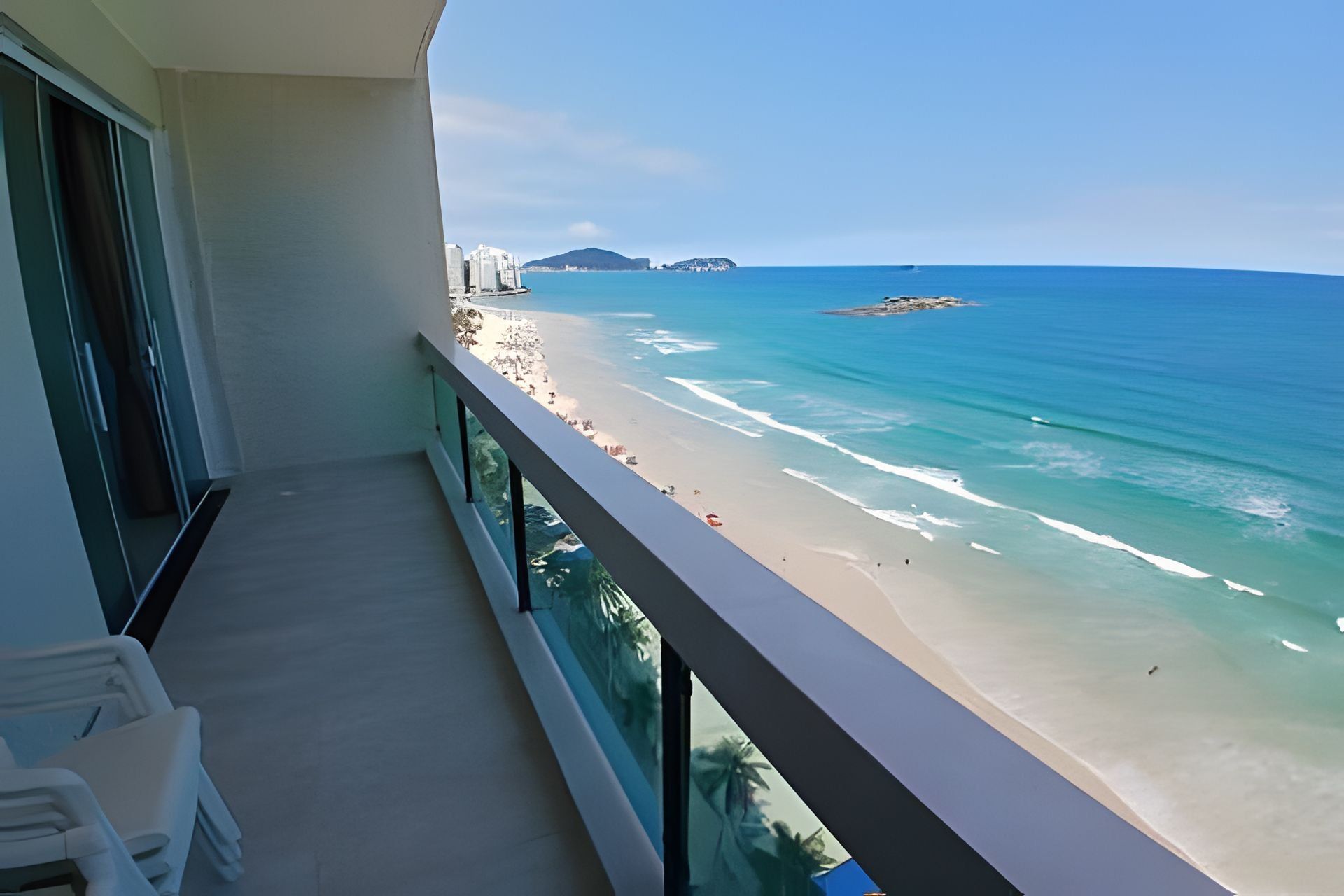 Een balkon met uitzicht op een strand en de oceaan.