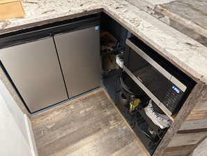A compact kitchen with a dishwasher, a microwave, and a wooden floor. - Charming apartment in awesome Louisville with cool AC breeze (Louisville)