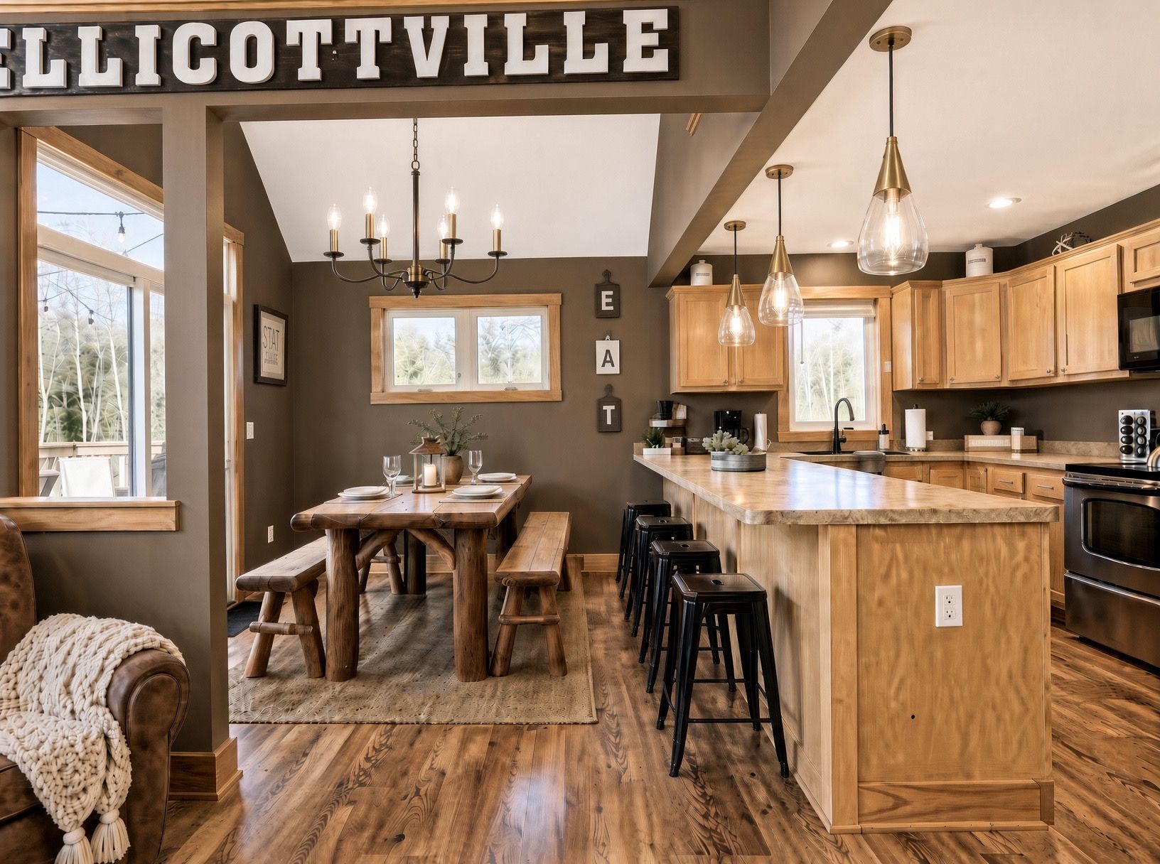 A modern kitchen with wooden cabinetry, a central island, bar stools, and pendant lighting.
