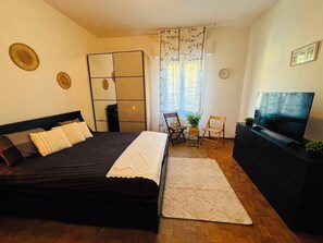 A bedroom with a bed, a TV, a desk, and a chair. - "K-one Firenze: Your Quiet Retreat," just a stone's throw from downtown Florence (Firenze)
