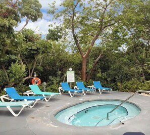 A pool area with lounge chairs and a lifebuoy. - Coconut Mallory~ Cozy Studio bungalow in tranquil Key West with AC (Key West)