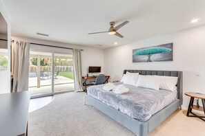 A modern bedroom with a bed, a desk, a chair, and a TV. - Private Backyard Oasis-Pool/Bocci/Golf (Palm Springs)