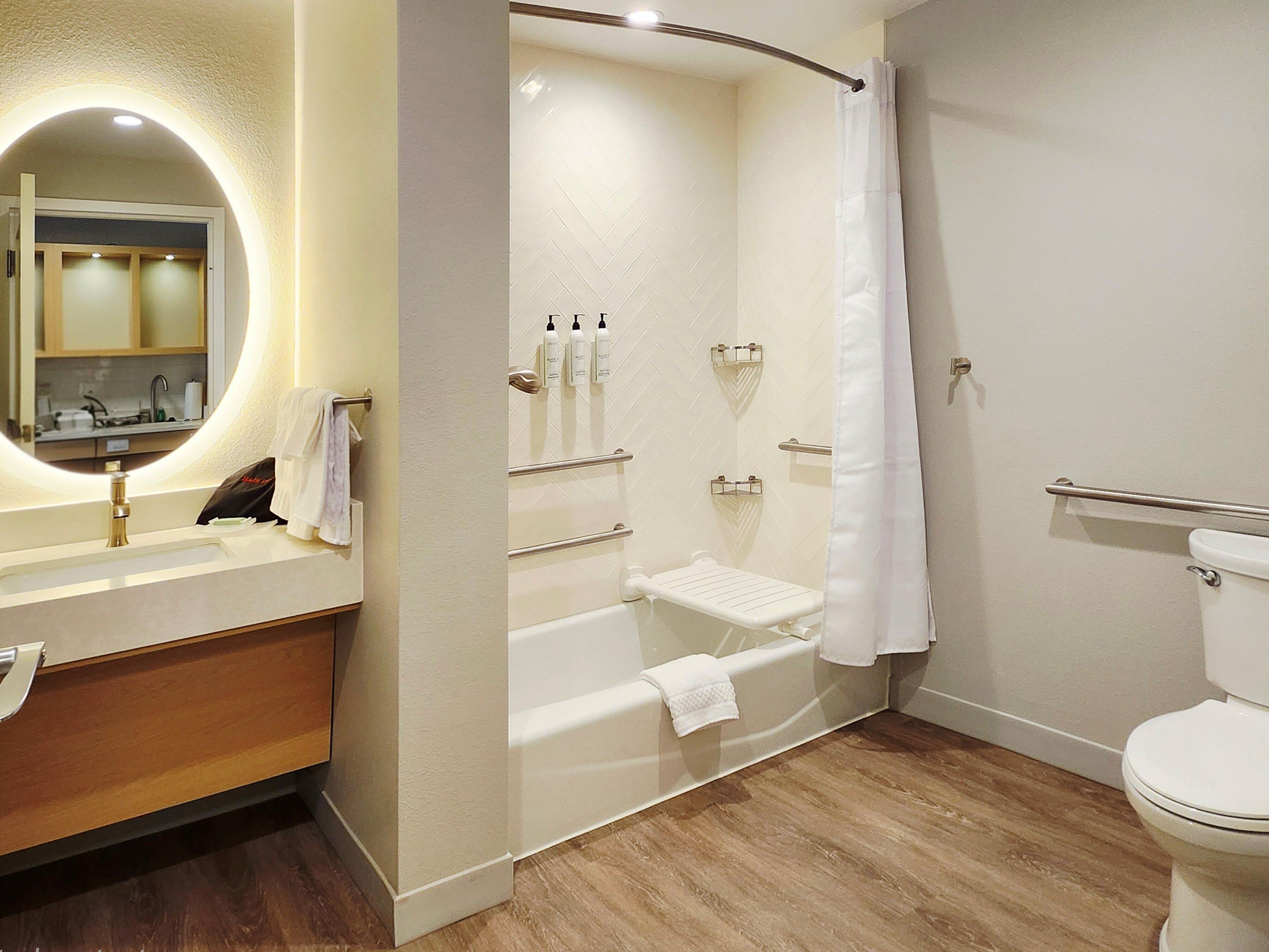A modern bathroom with a bathtub, a toilet, and a sink.