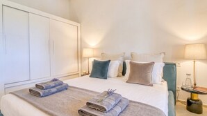 A hotel room with a bed, two side tables, a wardrobe, and a lamp. - Finca with pool in Can Treupoc, Porto Cristo (Manacor (Porto Cristo))
