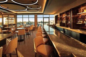 A bar area with seating and a view of the cityscape. - Orlando | Cozy Riviera Retreat | Pool + Resort (Lake Buena Vista)