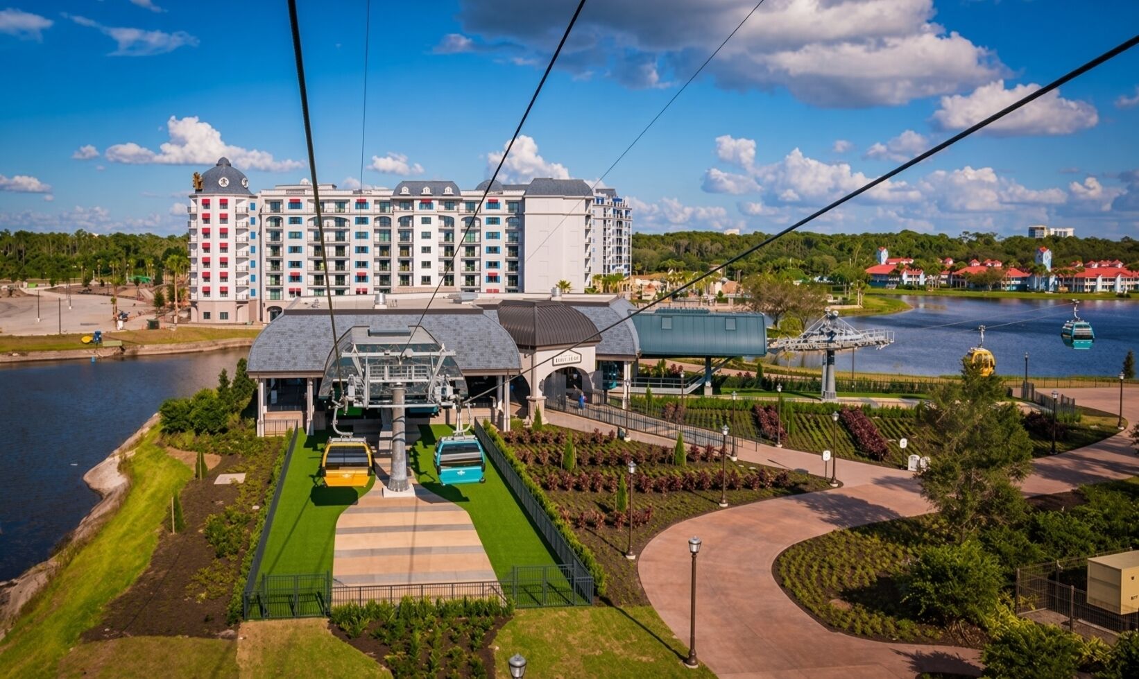 A cable car station with a building in the background.
