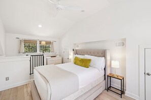 A bedroom with a bed, bedside table, lamp, window with curtains, and a ceiling fan. - Carriage House with Gulf Views (Rosemary Beach)