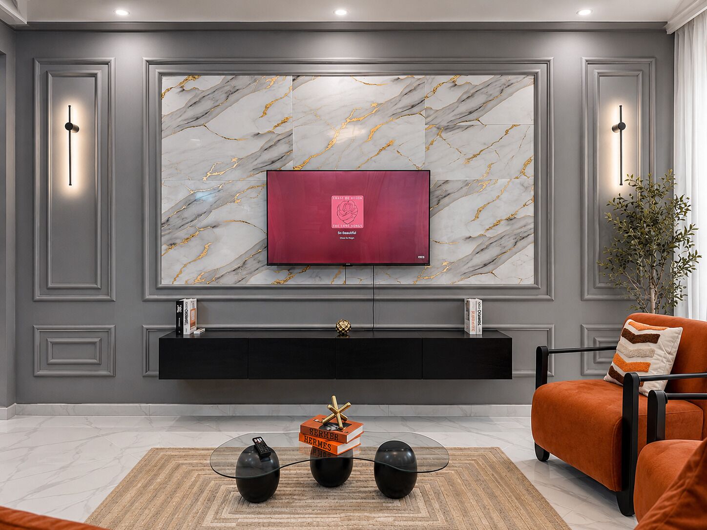 A modern living room with a marble-patterned wall, a flat-screen TV, a black entertainment unit, and a red sofa.
