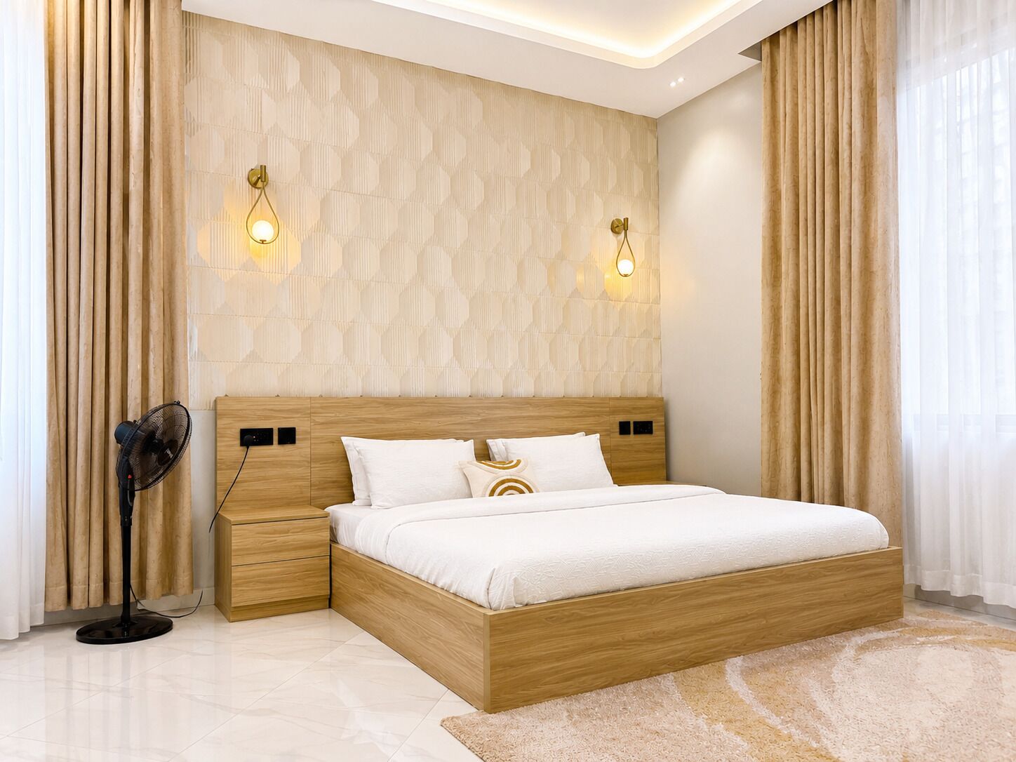 A modern bedroom with a wooden bed frame, a bedside table, a floor lamp, and a patterned wall.