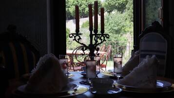 A dining table with plates, cups, and a candelabra.