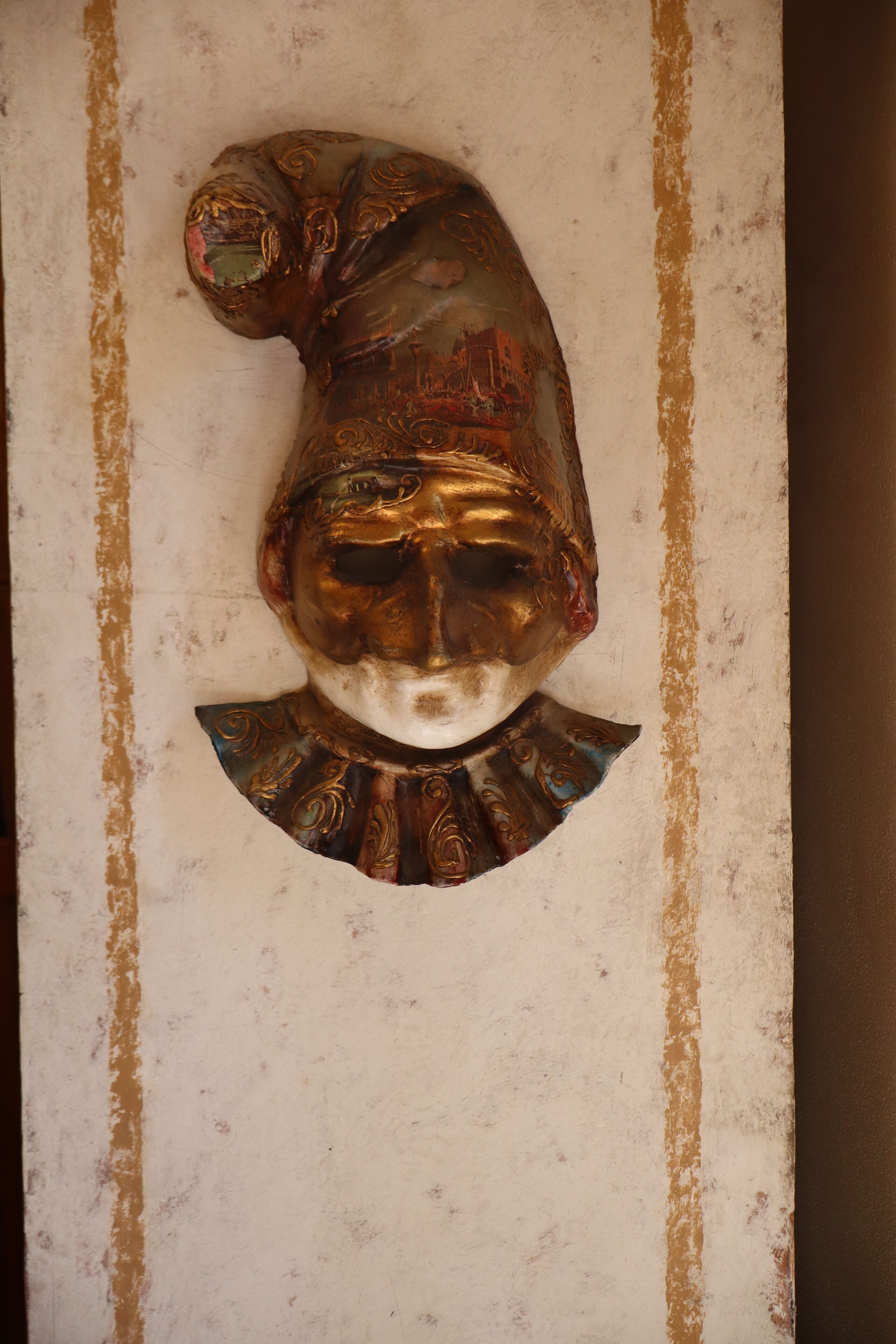 A decorative wall panel with a sculptural element.