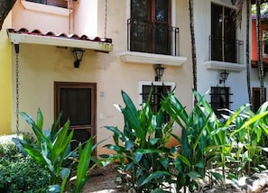 A building with a balcony, a door, and a window. - Garden Paradise, Walk to the Beach (Tamarindo)