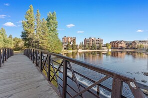 A wooden boardwalk leading to a body of water with buildings in the background. - 2BR Breckenridge Retreat | River Views, Pool & Hot Tubs Near Ski Lift (Breckenridge)