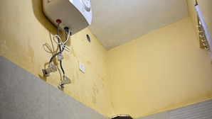 A bathroom with a shower, a sink, and a toilet.