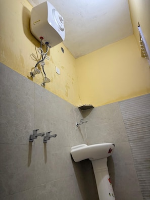 A bathroom with a shower, a sink, and a toilet.