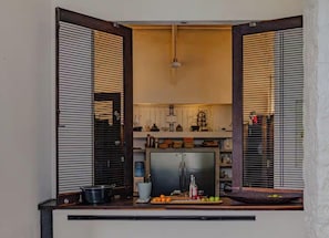 A kitchen with a built-in refrigerator, a sink, and a countertop with various items.