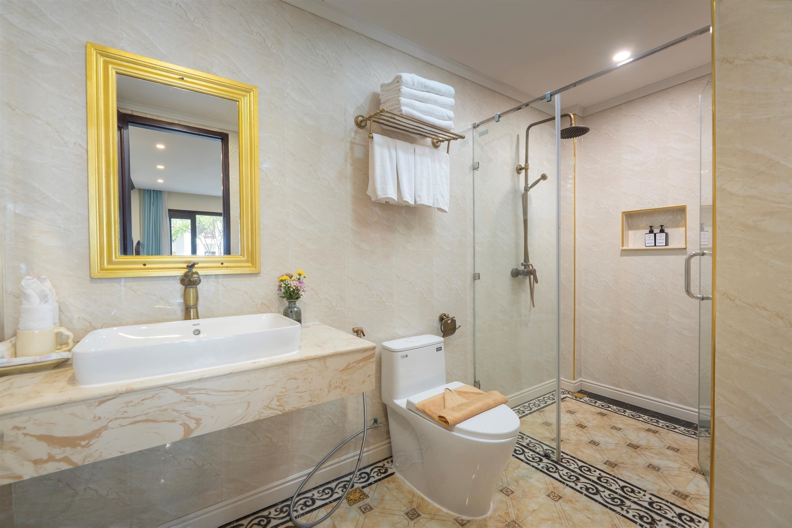 A bathroom with a bathtub, toilet, and shower.