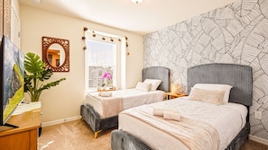 A bedroom with two beds, a large mirror, and a window with blinds. - Windsor Island 5BR Disney Home: Pool & Waterpark (Davenport)