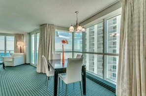 Bright dining area with floor-to-ceiling windows and city views. - Panaromic 2 /2 Condo, End Unit, Glass Wrapped, Highly Sought-after Floor Plan (Myrtle beach)