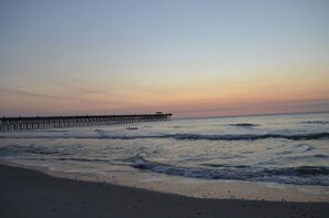 A beach with a pier extending into the water. - Panaromic 2 /2 Condo, End Unit, Glass Wrapped, Highly Sought-after Floor Plan (Myrtle beach)