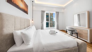 A modern hotel room with a large bed, a desk, a chair, and a large window with curtains. - Stayshort - Modern 2BR Apartment in Sulafa Tower Dubai Marina Near to Beach JBR - Sleeps 6 (Dubai)