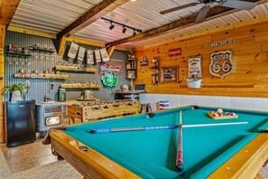 A pool table with billiard balls, a foosball table, and a neon sign. - Cabin w/ Hot Tub · Hear the Dollywood Whistle (Sevierville)