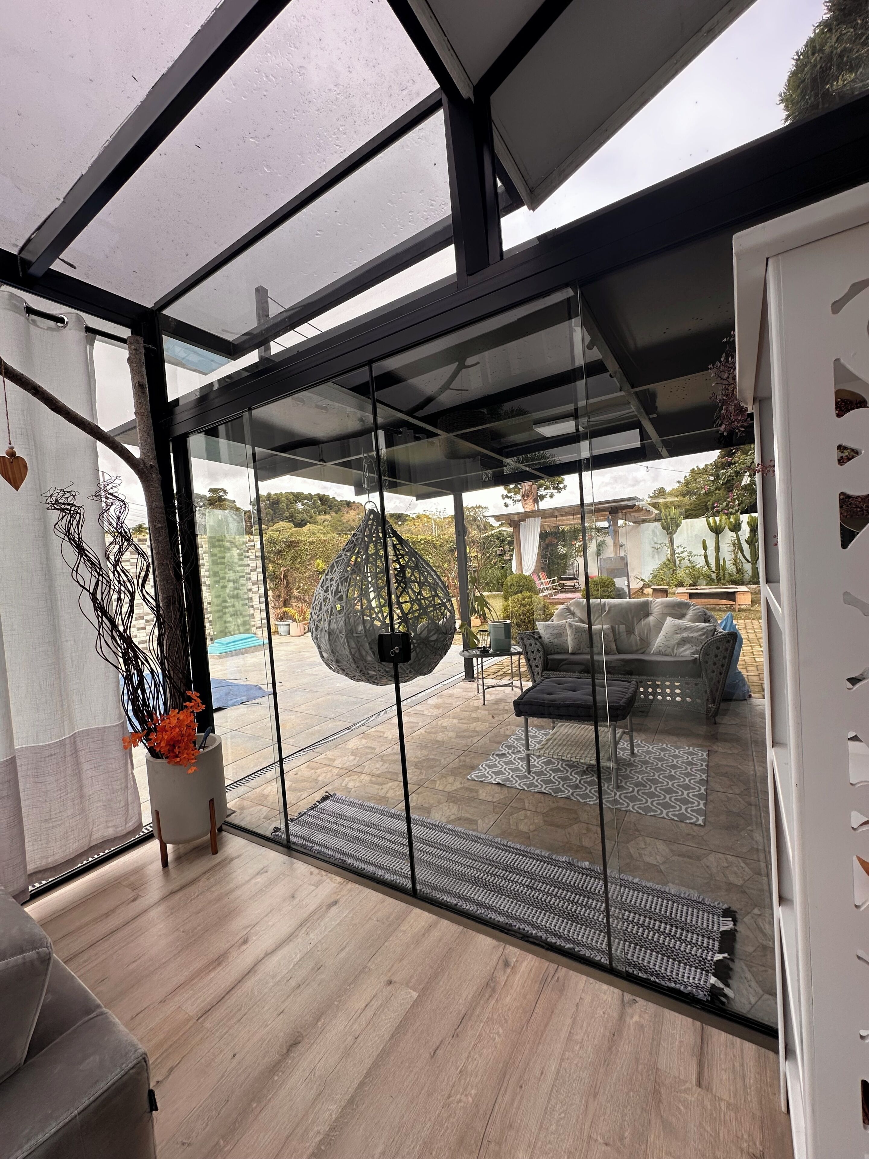 A modern interior with a glass door leading to an outdoor patio area.