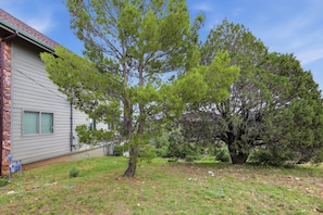 A residential property with a house, a lawn, and a large tree. - Cozy 1BR casita with stunning panoramic views (Prescott)
