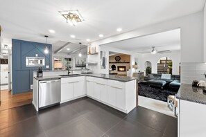 A modern kitchen with white cabinets, a built-in microwave, and a large island. - The Chateau Elan of Atlanta with Courtyard Hot tub (Atlanta)