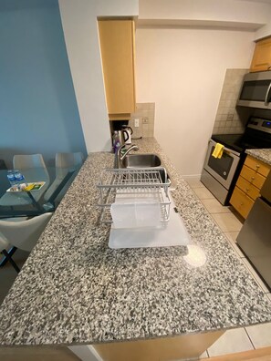 Coffee/tea maker, fridge, microwave, oven - Modern 22nd-Floor Condo Steps from Subway (Toronto)