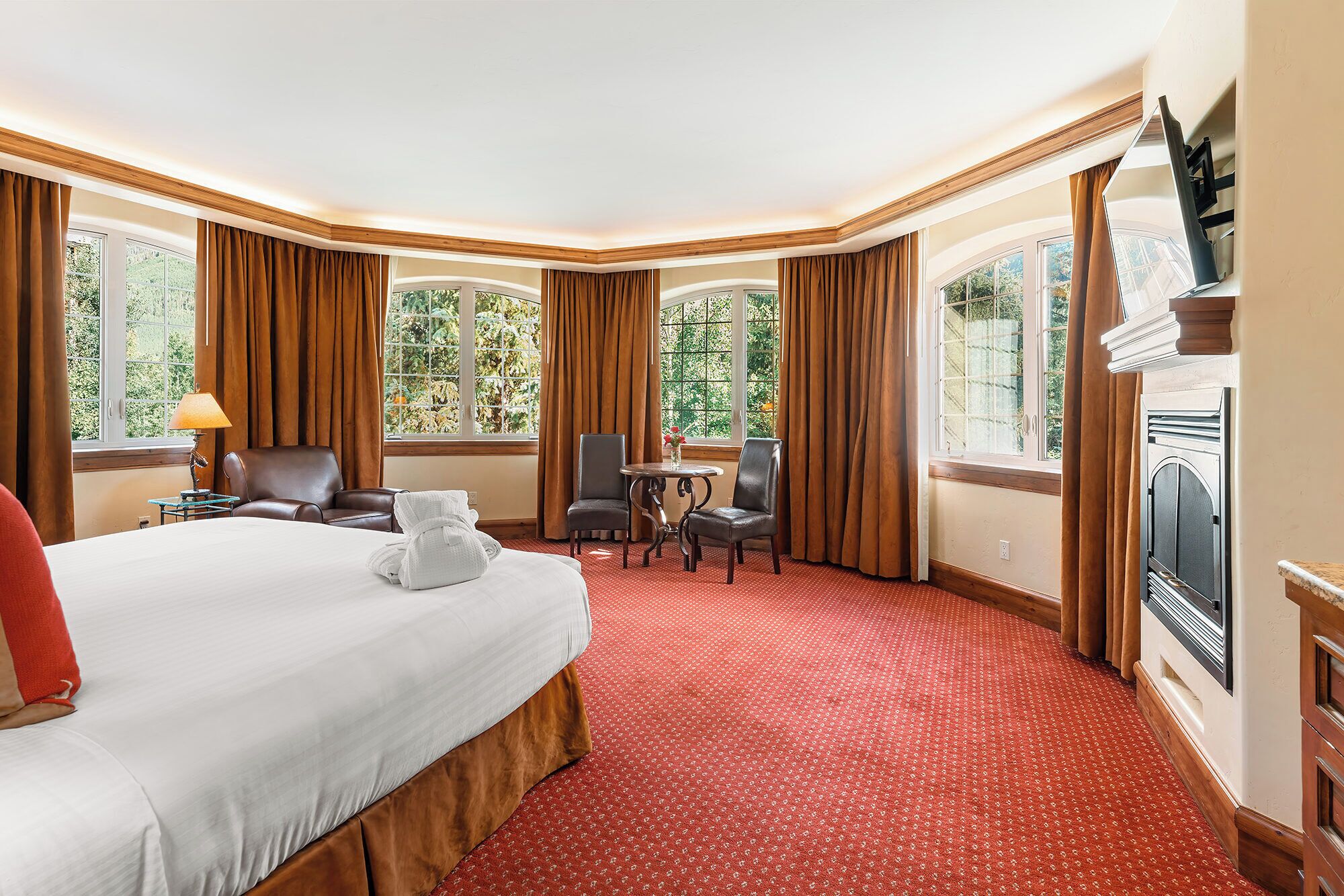 Unwind by the fireplace in a plush, spacious king bed.