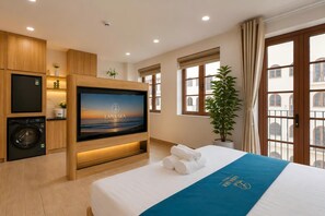 A hotel room with a bed, a television, a washing machine, and a window with a view. - LANA SEA HOTEL & APARTMENT (An Thoi)