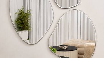 Three wall-mounted mirrors of varying shapes.