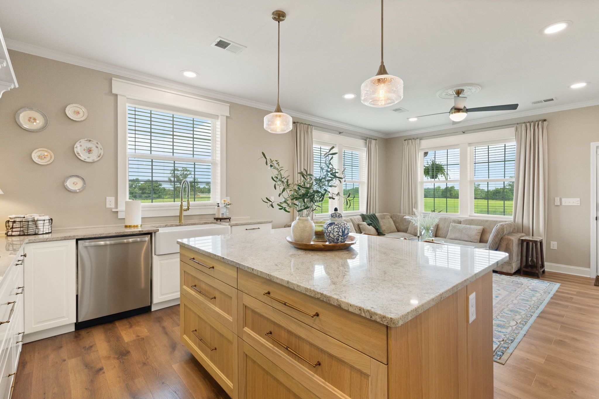 A modern kitchen with a central island, wooden cabinets, and a dishwasher.