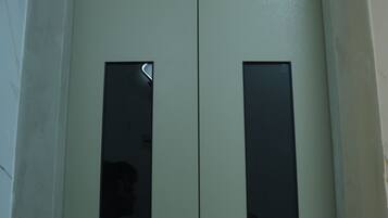 A double door with rectangular windows, likely an elevator or service door.