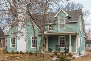 A two-story house with a porch, a chimney, and a number '43' on the front. - The Storybook Stay / Woodson Historic District (Gallatin)