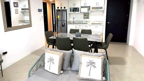 A compact kitchen with white cabinets, a built-in oven, and a refrigerator. - Apartment in Punta Centinela Townhouse 200 (Santa Elena)