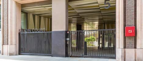 A gated entrance to a building with a sign reading 'SAXON COURT.'