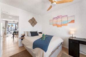 A bedroom with a bed, a desk, a ceiling fan, and artwork on the wall. - Home2Book Golden Apt Pool & Terrace Costa Teguise (Costa Teguise)