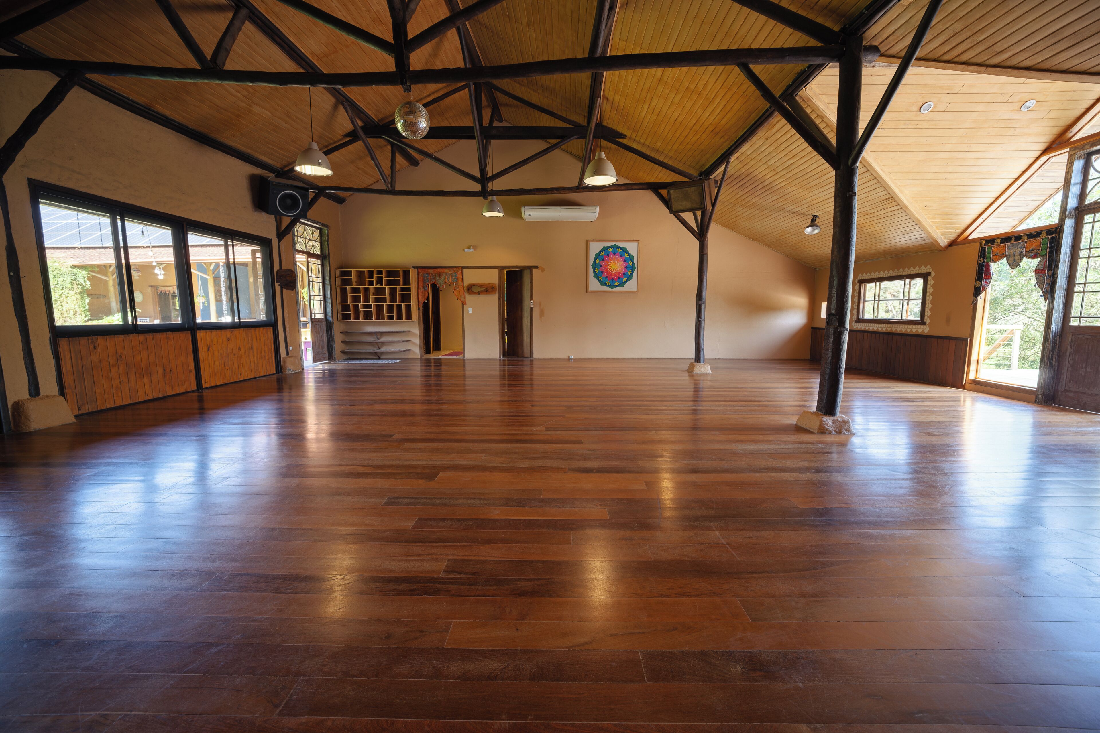 Ein geräumiger Saal mit hoher Decke und Holzbalken.