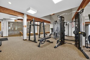 A gym with various exercise equipment, a mirror, and a carpeted floor. - Meadow Ridge Retreat | Pool, Hot Tub & Near Winter Park (Fraser)