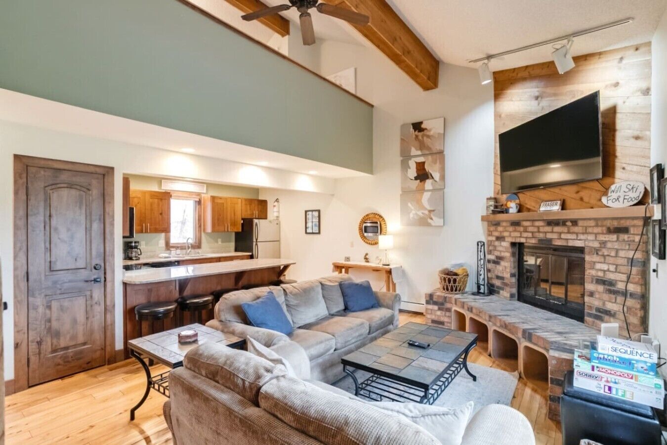 A cozy living room with a sofa, a coffee table, and a fireplace.