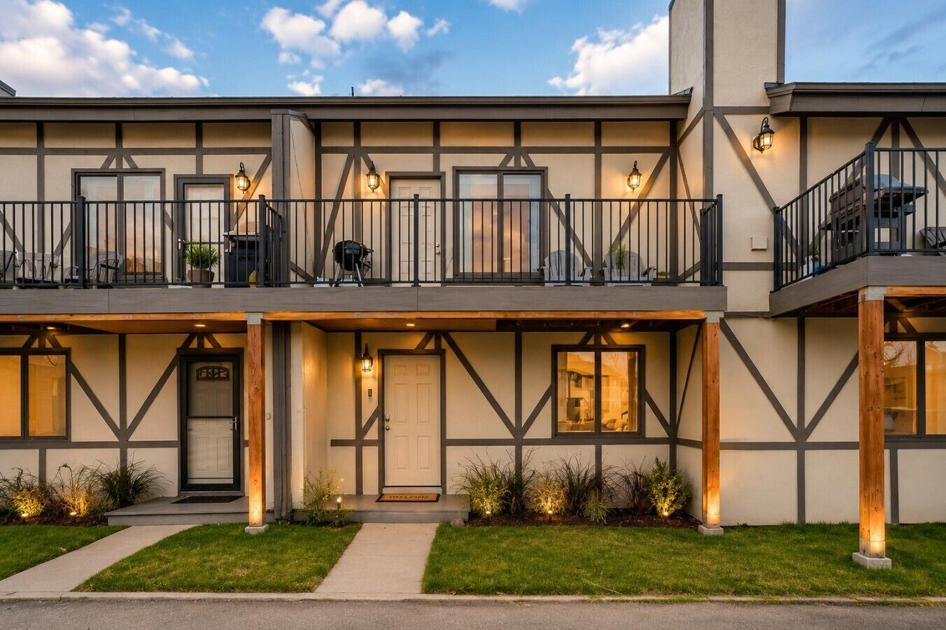 A two-story building with a balcony, a door, and a window.