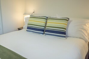 A bed with white bedding and two striped pillows. - House near Snowbird, Alta - Hot Tub, Games (Sandy)