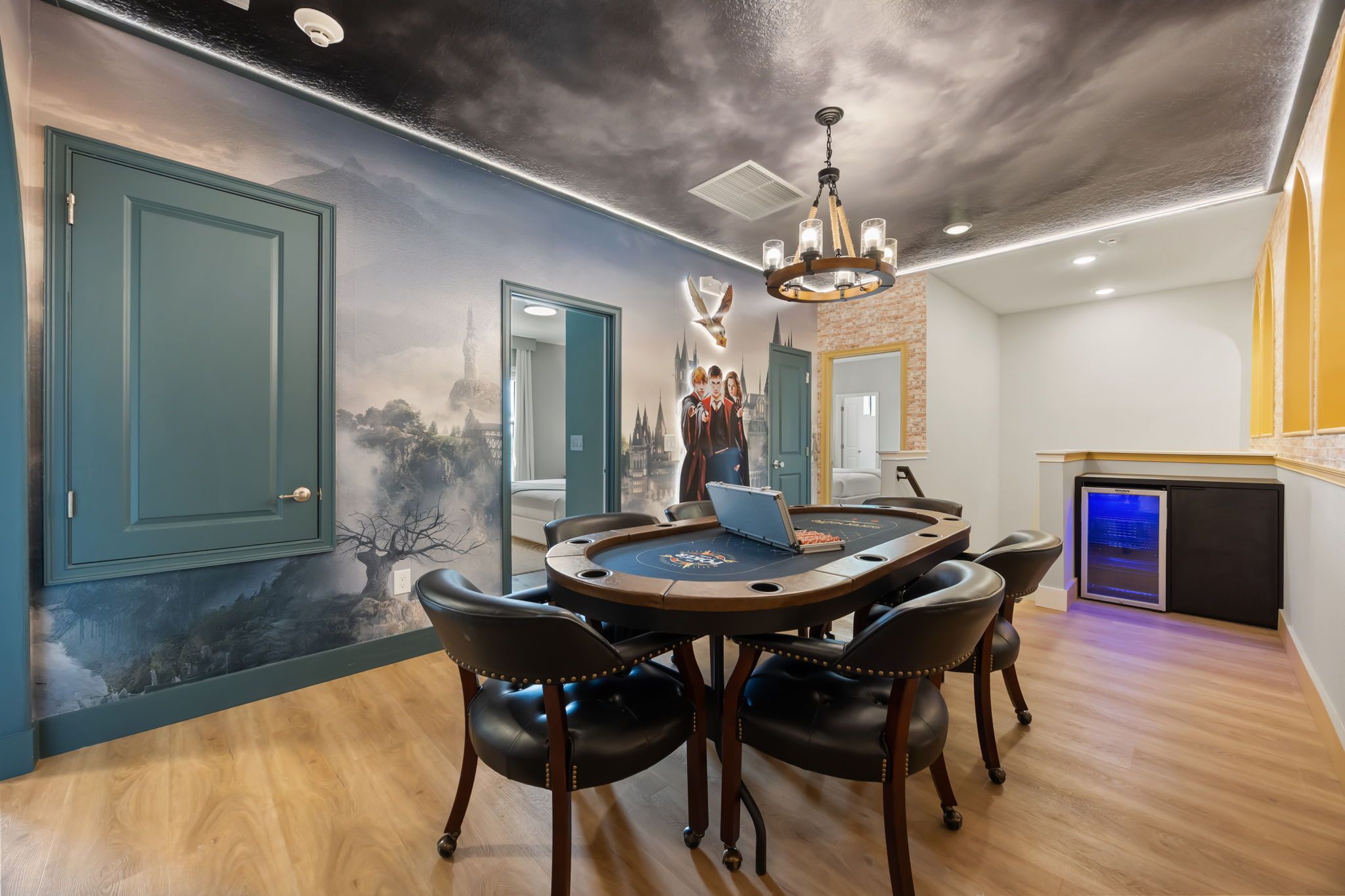 A dining area with a round table, chairs, and a laptop.