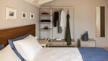 A bedroom with a bed, a bedside table, a wardrobe, and a mirror.