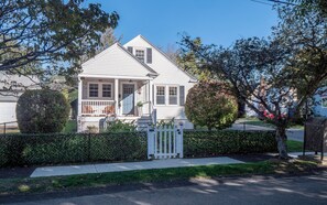 A two-story house with a front porch, a chimney, and a mailbox. - 2-bedroom Private Newport Retreat (Newport)