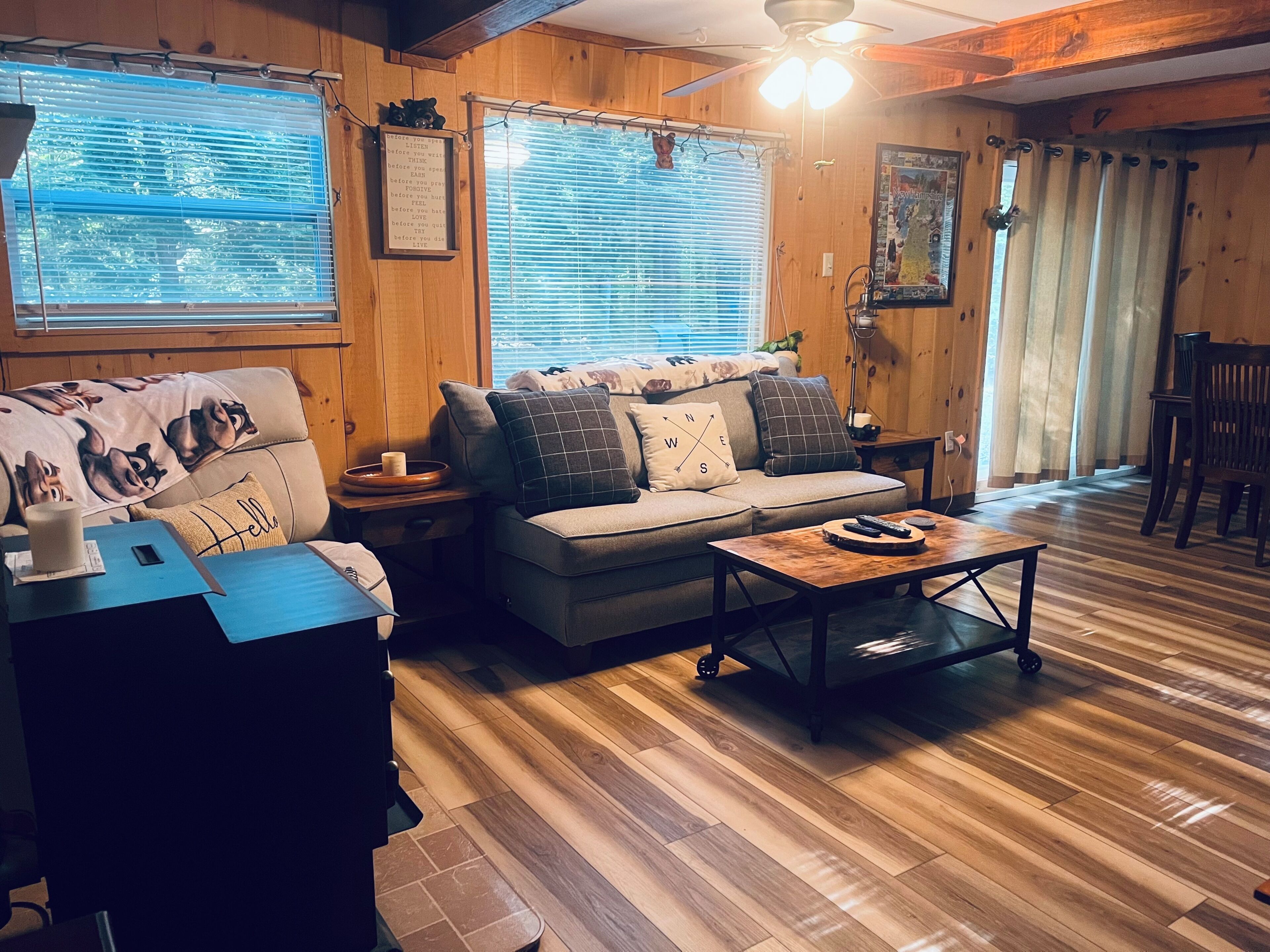 A cozy living room with a sofa, a coffee table, and a television.