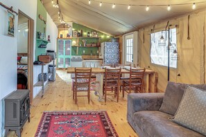 A cozy interior with a dining area, kitchen, and seating space.