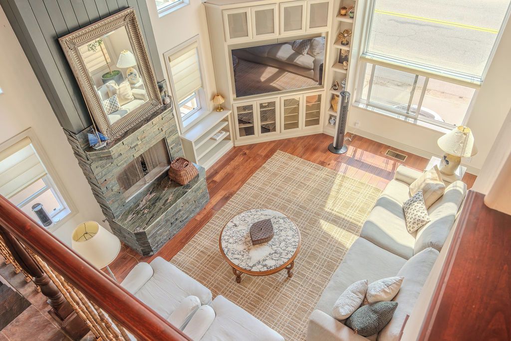 A living room with a fireplace, a television, and a sofa.